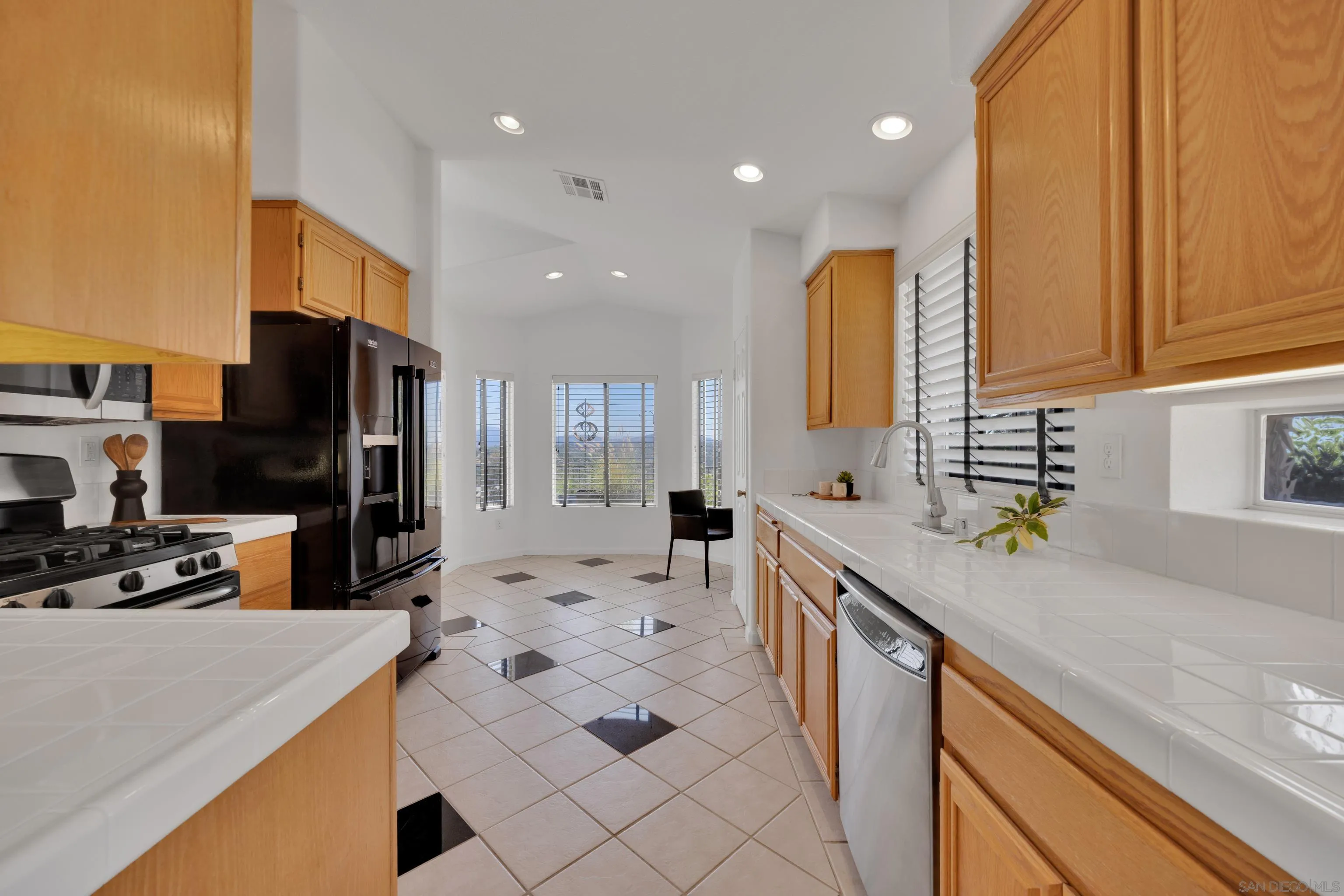 2334 Columbine Road Alpine, CA 91901 - Photo 11 of 42 a kitchen with a sink a counter top space appliances and cabinets