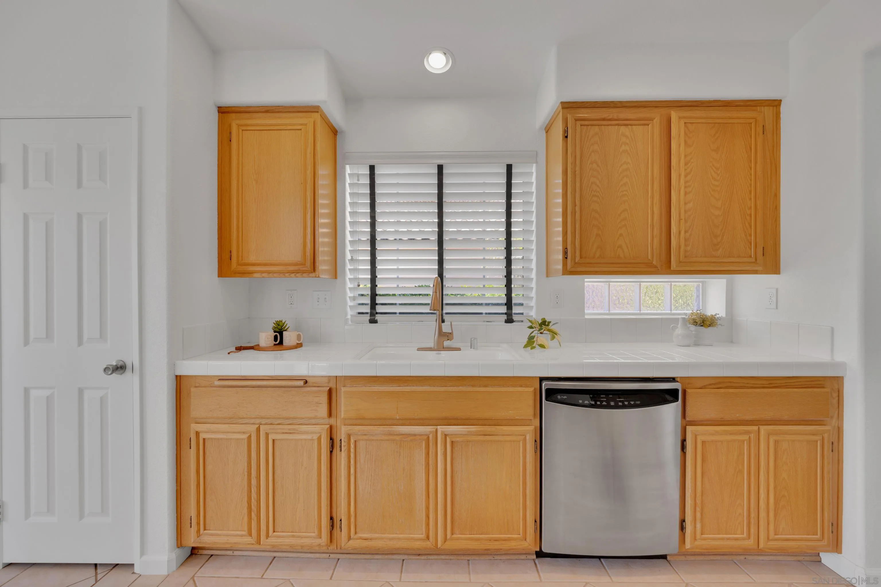 2334 Columbine Road Alpine, CA 91901 - Photo 13 of 42 a kitchen with white cabinets and sink