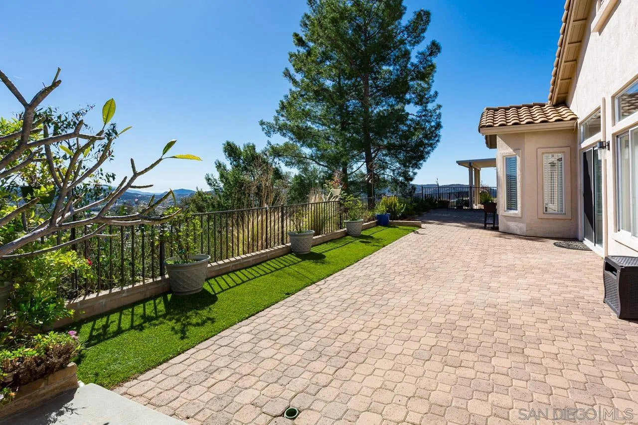 2334 Columbine Road Alpine, CA 91901 - Photo 19 of 42 a view of a house with a small yard and wooden fence