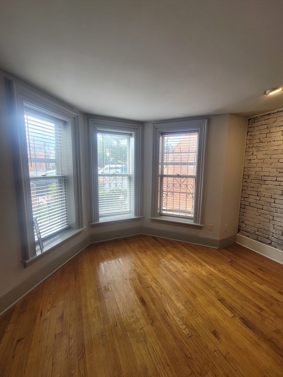 74 Temple Street, Unit 1 Springfield, MA 01105 - Photo 4 of 11 a view of an empty room with a window and wooden floor
