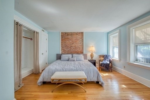 74 Temple Street, Unit 1 Springfield, MA 01105 - Photo 6 of 11 a bedroom with a bed and wooden floor