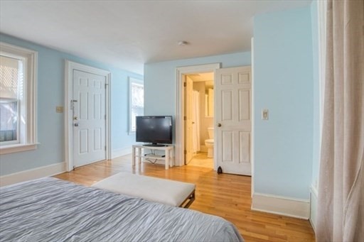 74 Temple Street, Unit 1 Springfield, MA 01105 - Photo 7 of 11 a bedroom with a bed and wooden floor