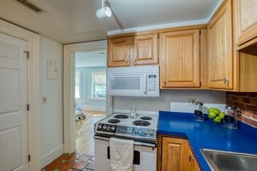 74 Temple Street, Unit 1 Springfield, MA 01105 - Photo 10 of 11 a kitchen with stainless steel appliances granite countertop a stove a sink and a refrigerator