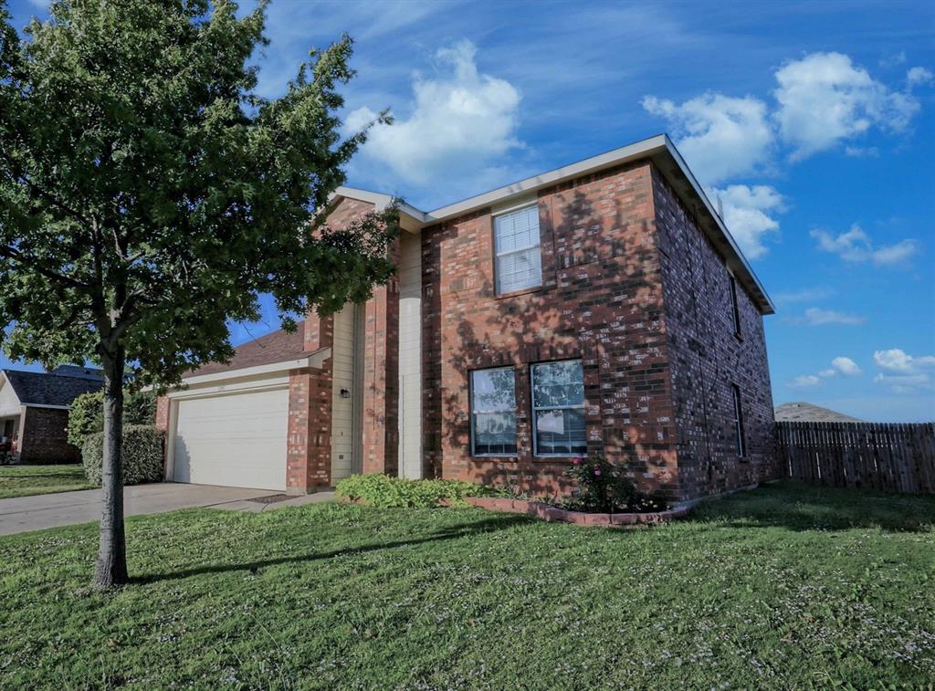12005 Arbor Lake Road Rhome, TX 76078 - Photo 1 of 22 View of front of home featuring driveway, brick siding, and an attached garage