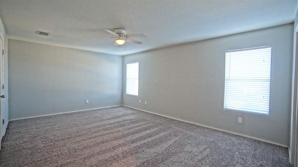 12005 Arbor Lake Road Rhome, TX 76078 - Photo 11 of 22 Carpeted empty room featuring ceiling fan and a textured ceiling