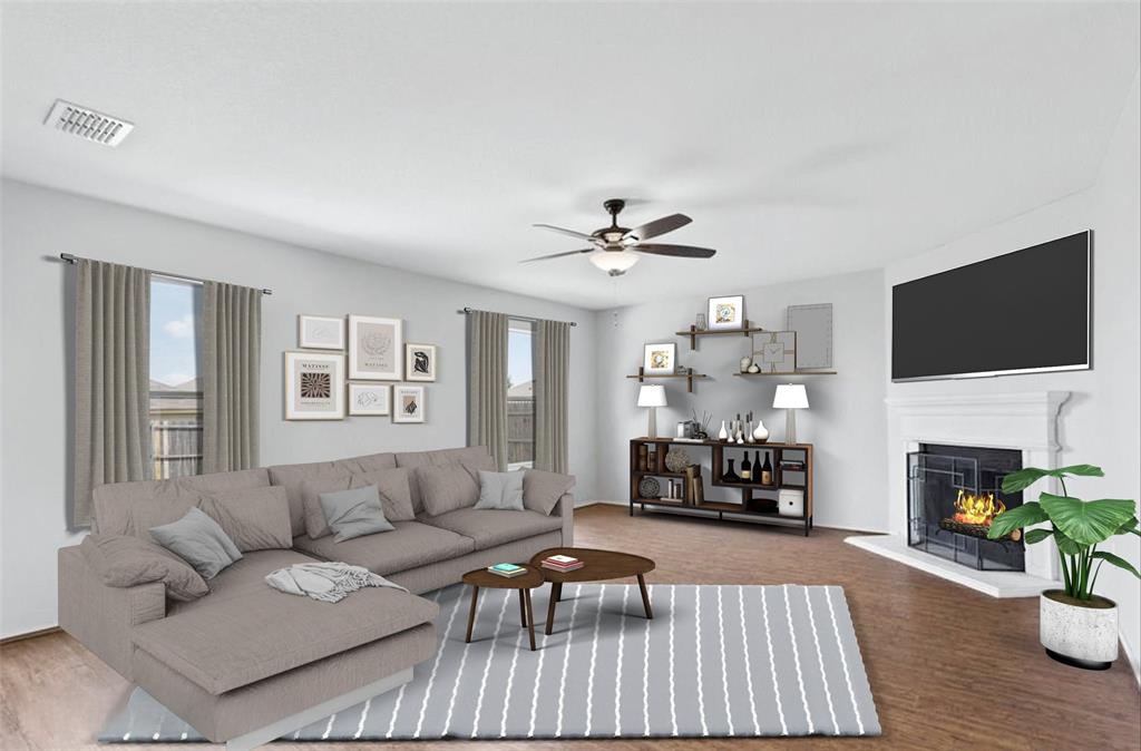 12005 Arbor Lake Road Rhome, TX 76078 - Photo 2 of 22 Living area featuring a lit fireplace, a ceiling fan, and wood finished floors