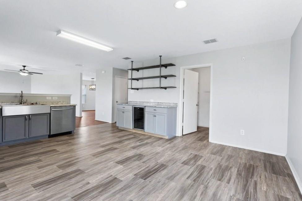 12005 Arbor Lake Road Rhome, TX 76078 - Photo 22 of 22 Kitchen with open shelves, open floor plan, ceiling fan, dishwasher, and light countertops