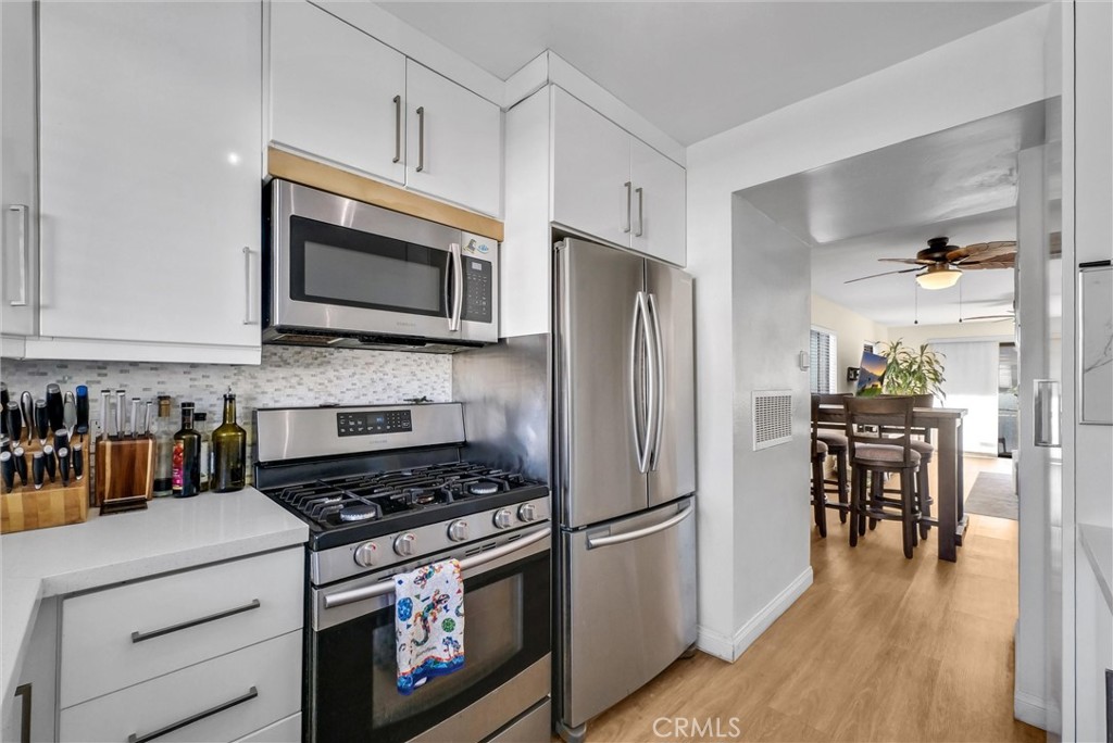 24351 Pasto Road Dana Point, CA 92629 - Photo 12 of 30 a kitchen with stainless steel appliances a stove a microwave and a refrigerator