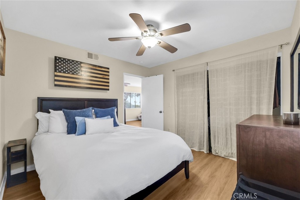 24351 Pasto Road Dana Point, CA 92629 - Photo 14 of 30 a bedroom with a large bed and a ceiling fan