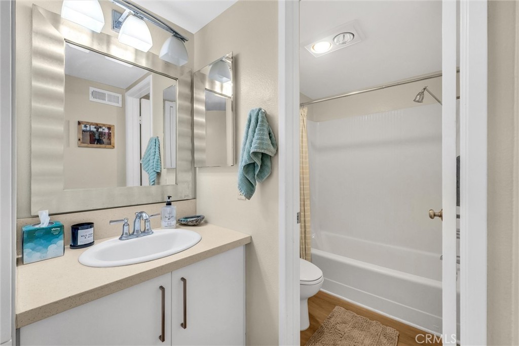 24351 Pasto Road Dana Point, CA 92629 - Photo 15 of 30 a bathroom with a granite countertop sink a toilet and shower