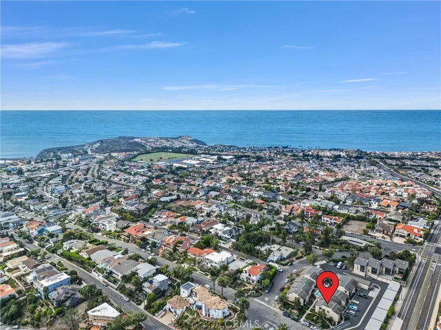 an aerial view of residential building and ocean
