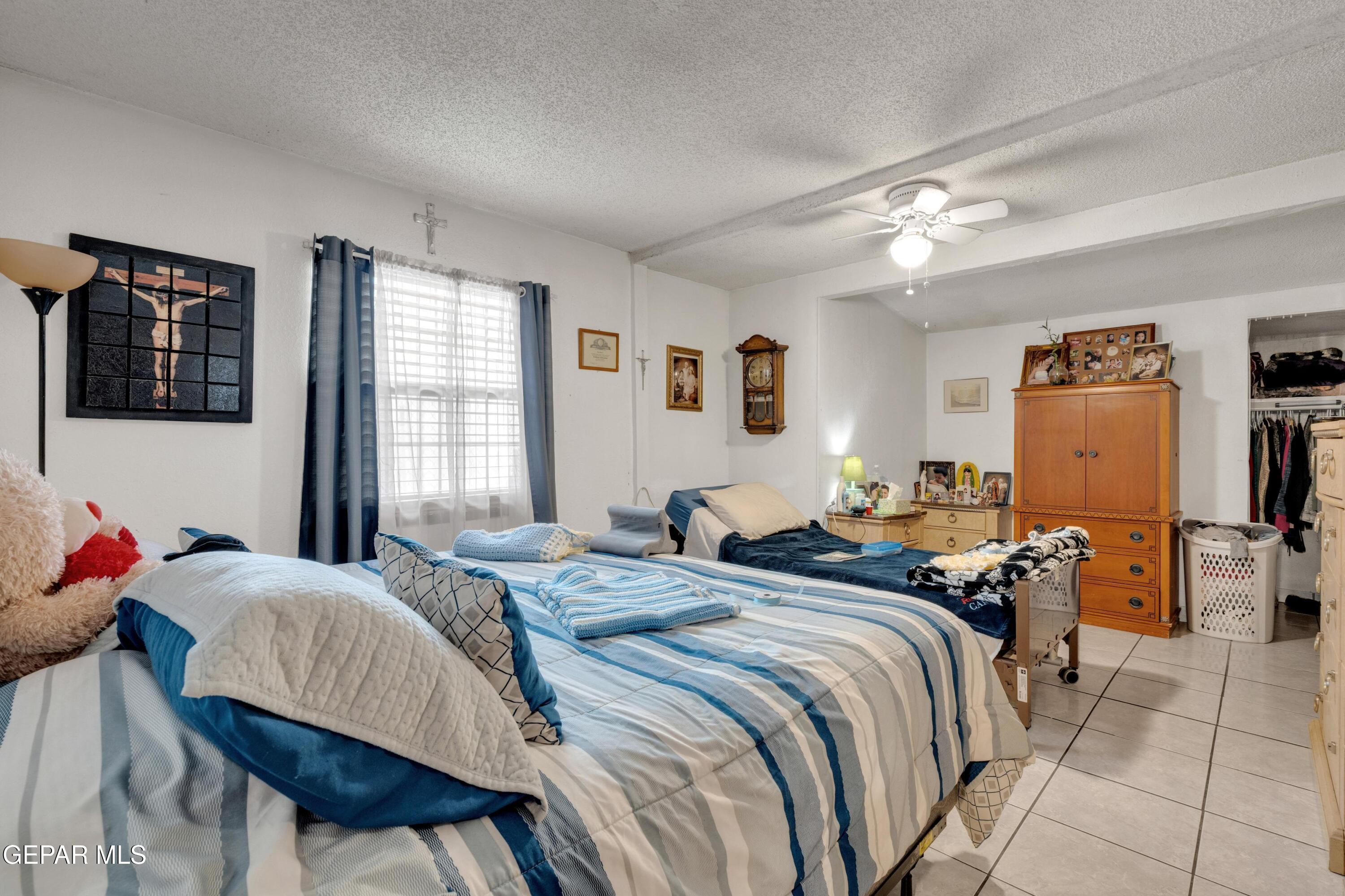 810 Silvestre Road El Paso, TX 79907 - Photo 23 of 33 a bedroom with a bed and wooden floor