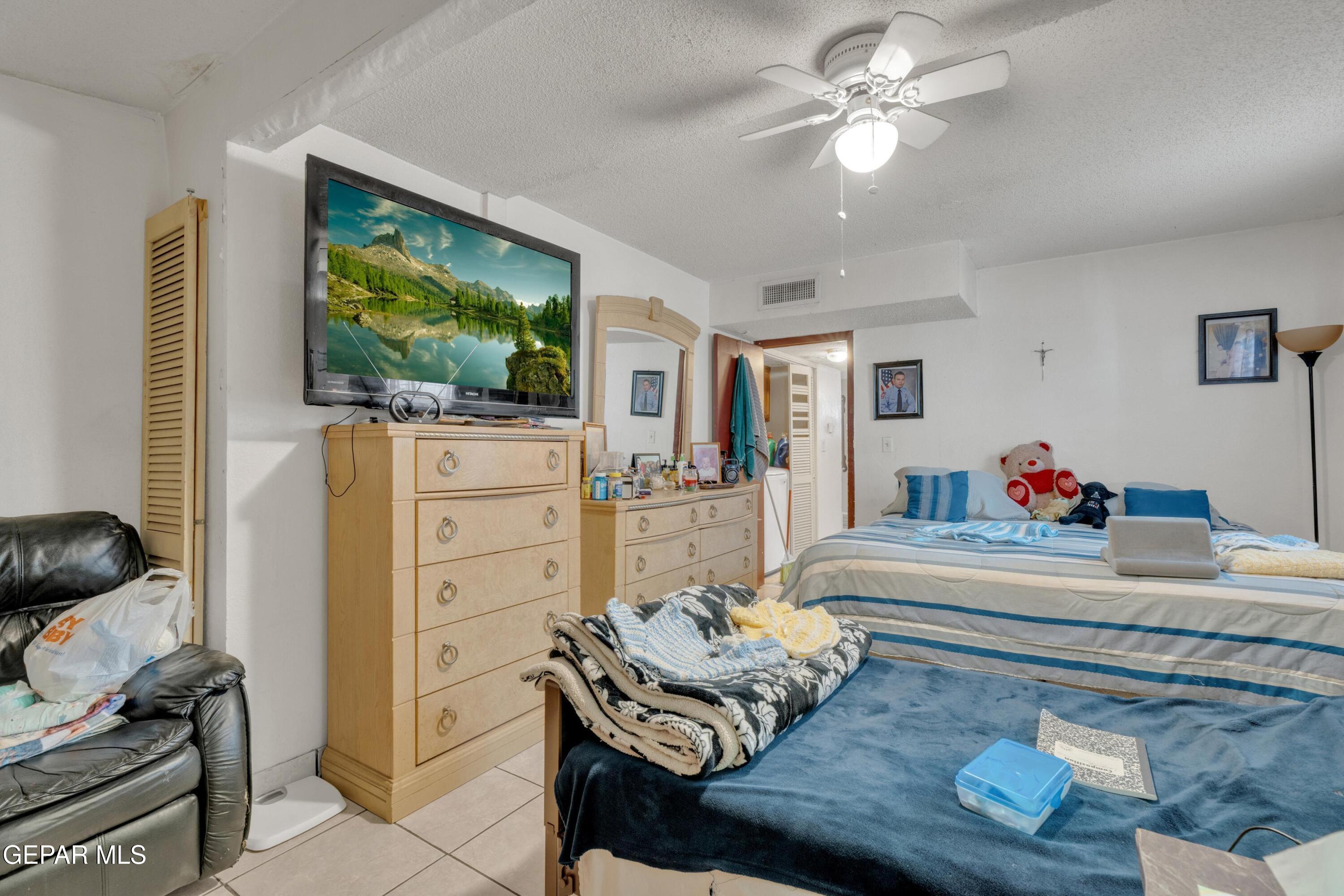 810 Silvestre Road El Paso, TX 79907 - Photo 24 of 33 a living room with furniture and a flat screen tv