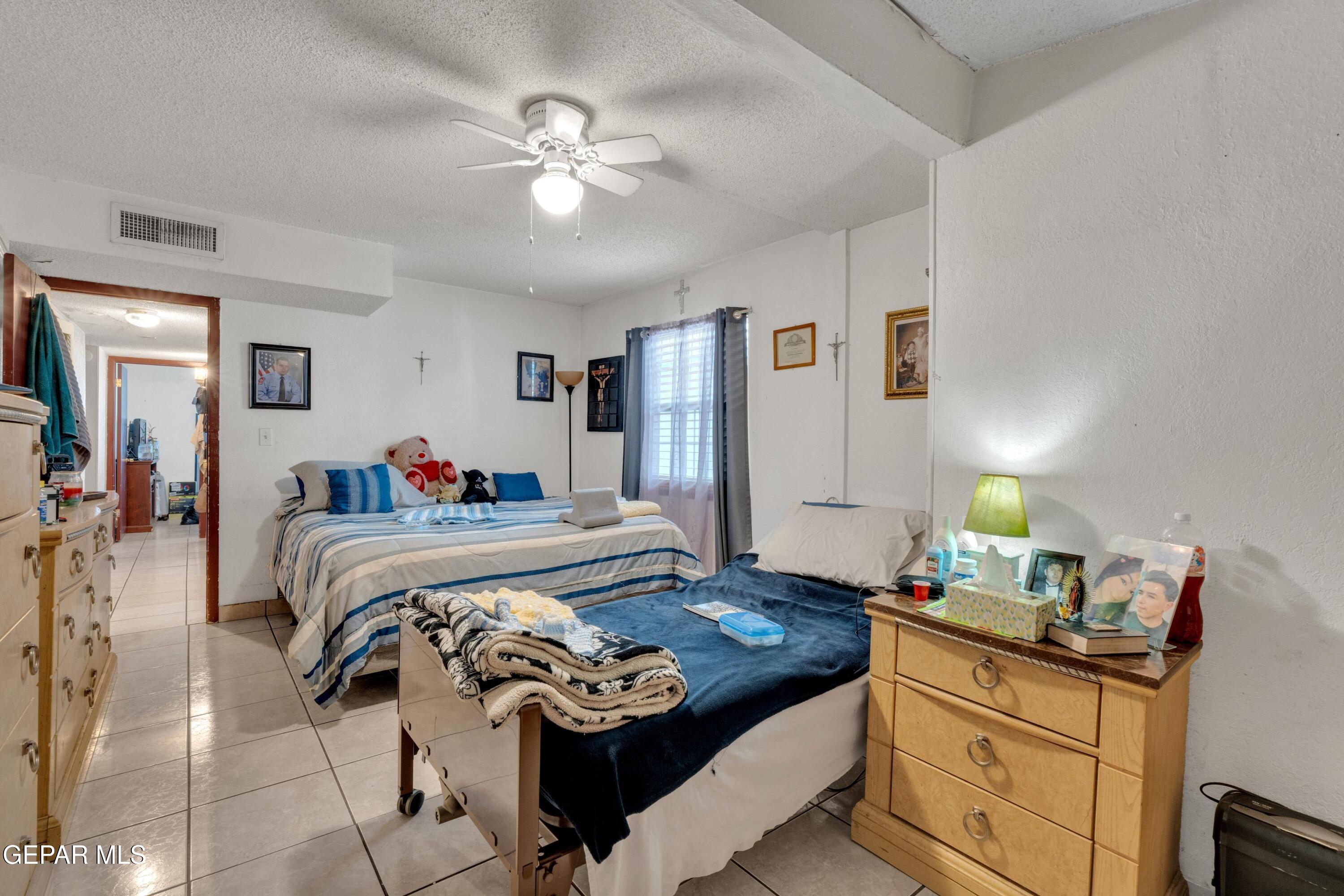 810 Silvestre Road El Paso, TX 79907 - Photo 25 of 33 a bedroom with a bed and a chandelier