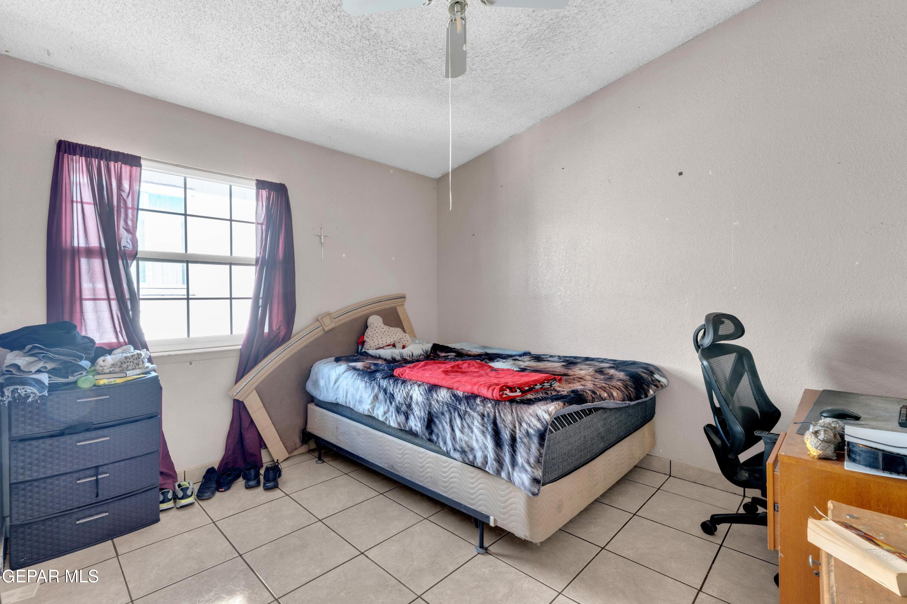 810 Silvestre Road El Paso, TX 79907 - Photo 27 of 33 a bedroom with a bed and a window