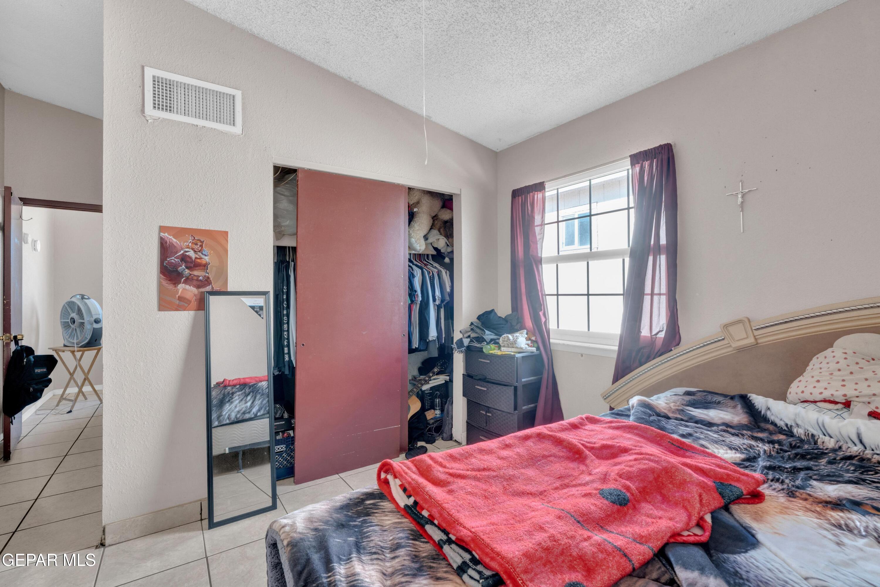 810 Silvestre Road El Paso, TX 79907 - Photo 28 of 33 a bedroom with a bed and a dresser next to a window
