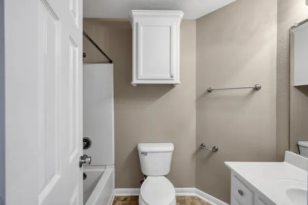 a bathroom with a toilet a sink and bathtub