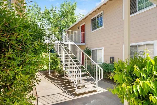 a view of a house with balcony and wooden floor