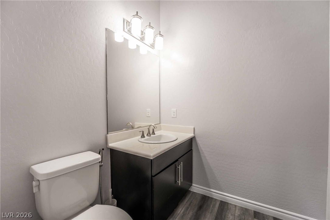2787 Athens Ridge Drive Henderson, NV 89052 - Photo 9 of 31 A well-lit powder room offers contemporary fixtures and rich dark cabinetry.