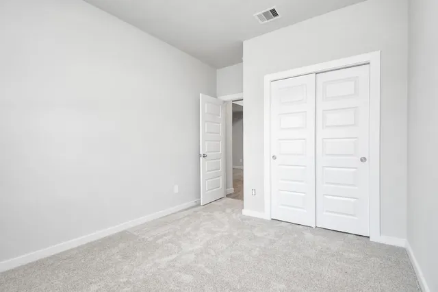 a view of kitchen with granite countertop white cabinets and white appliances