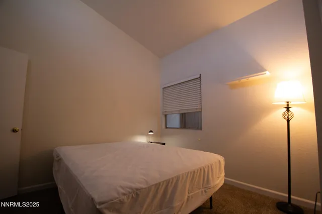 a bedroom with a bed and a night stand