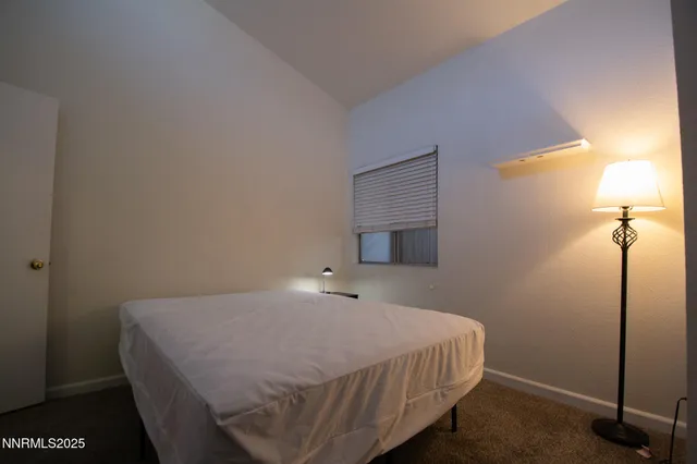 a bedroom with a bed and a night stand