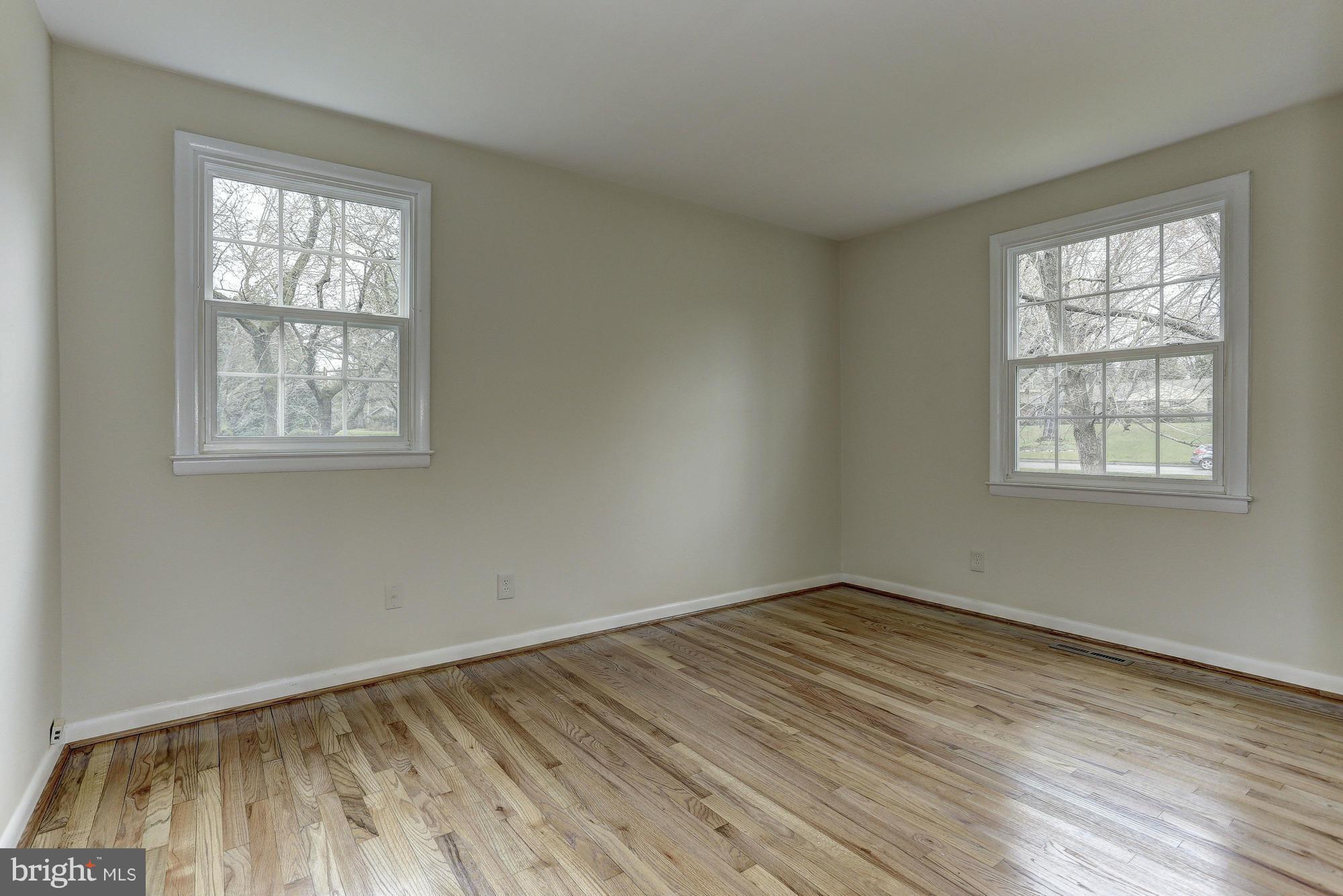 5010 Durham Road East Columbia, MD 21044 - Photo 14 of 30 an empty room with wooden floor and windows