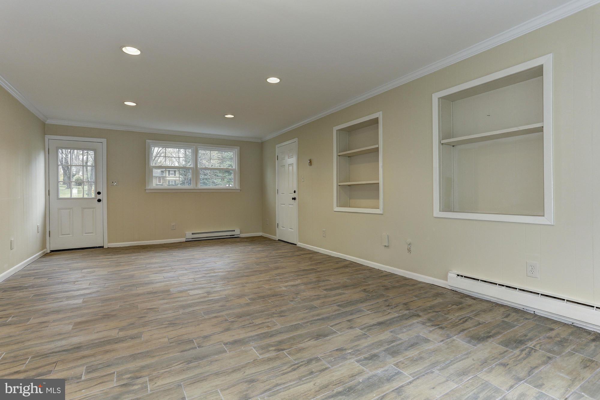 5010 Durham Road East Columbia, MD 21044 - Photo 22 of 30 an empty room with wooden floor and windows