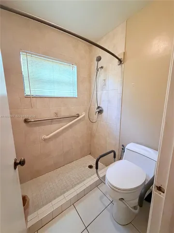 a bathroom with a toilet and a shower