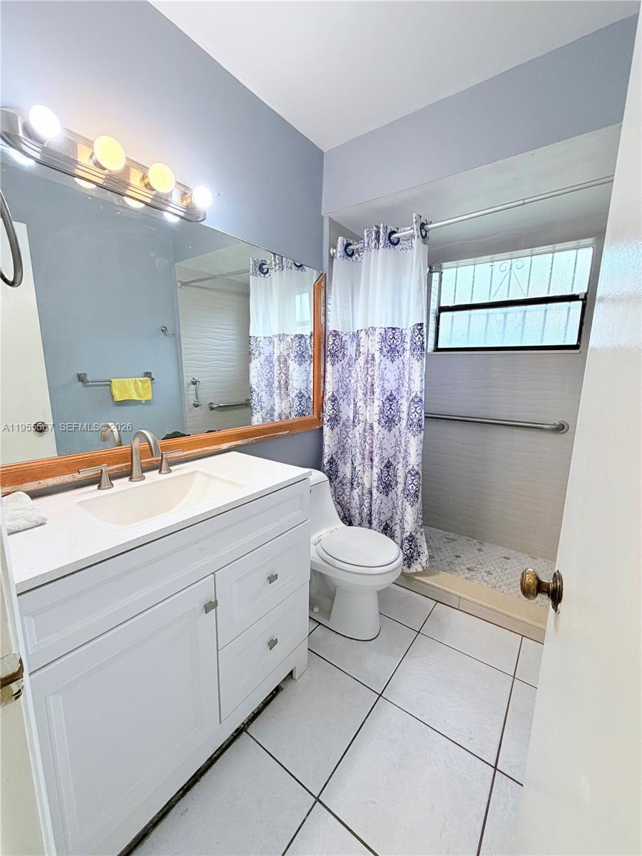 11334 Southwest 152nd Terrace Miami, FL 33157 - Photo 6 of 20 a bathroom with a sink toilet and shower