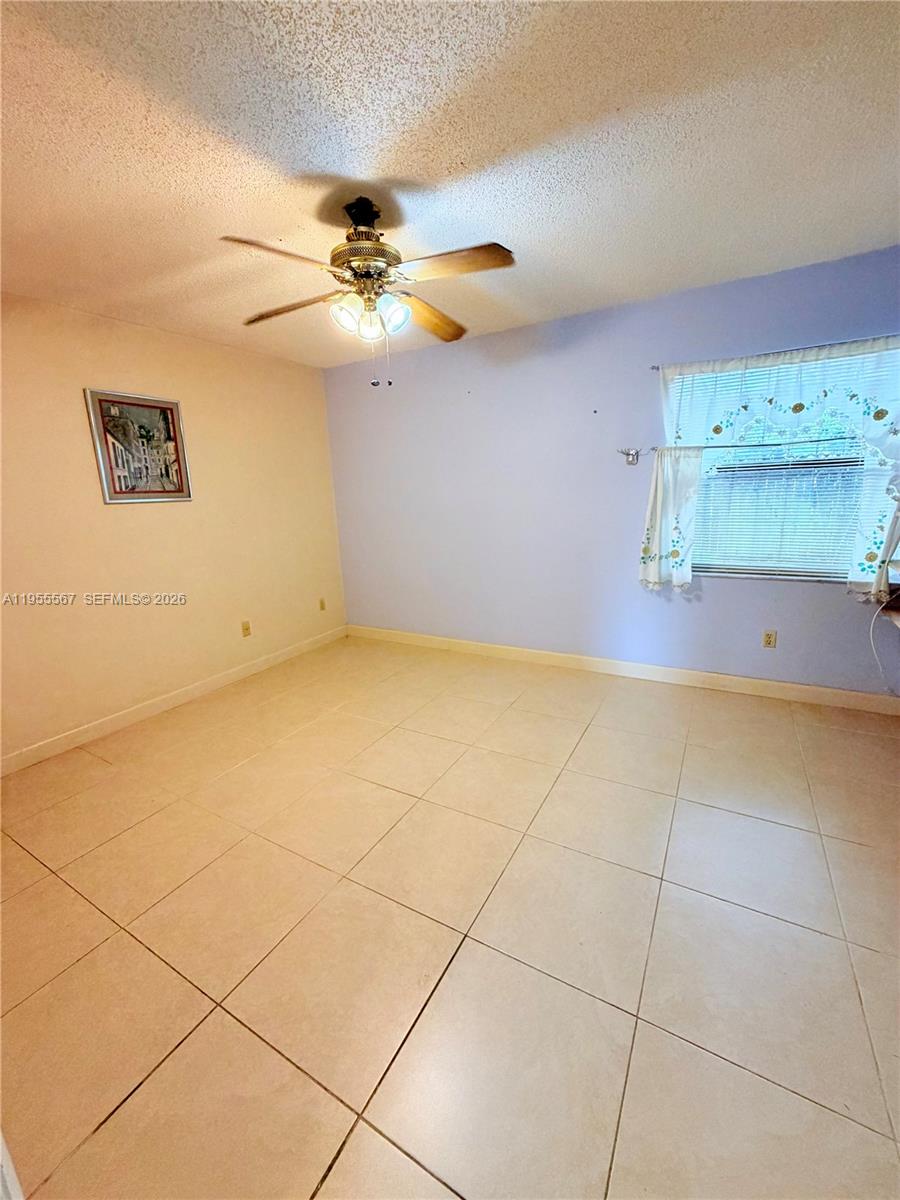 11334 Southwest 152nd Terrace Miami, FL 33157 - Photo 7 of 20 a view of room with a ceiling fan and window