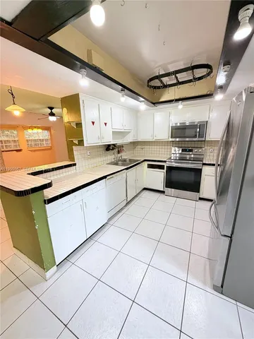a kitchen with stainless steel appliances granite countertop a sink and cabinets