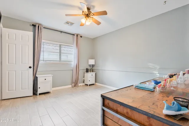 a view of a room with cabinet and ceiling fan