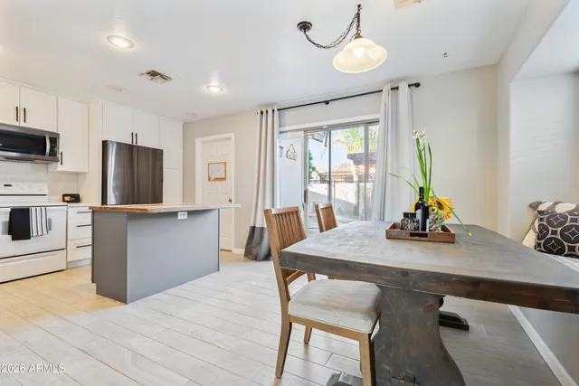 a kitchen with stainless steel appliances wooden floor and refrigerator