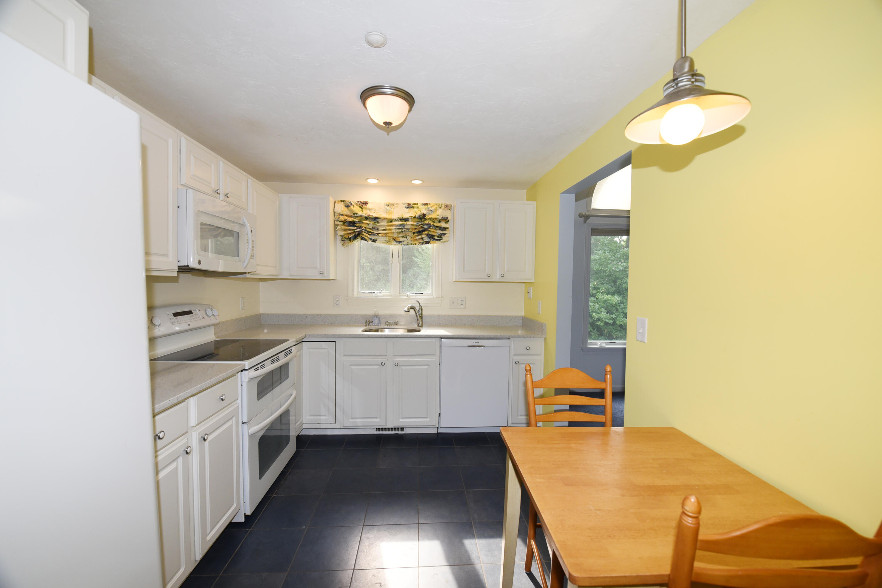23 North Ridge Road Mashpee, MA 02649 - Photo 4 of 38 a kitchen with a sink cabinets and window