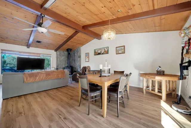 a kitchen with stainless steel appliances granite countertop a refrigerator a stove a sink dishwasher and a microwave with wooden floor