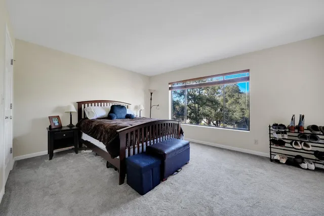 a bedroom with a bed and a chair