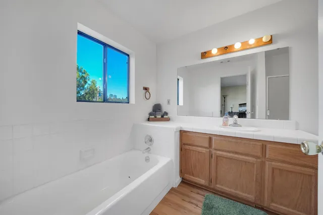 a bathroom with a sink a toilet and mirror