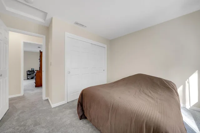 a bedroom with a bed and a table