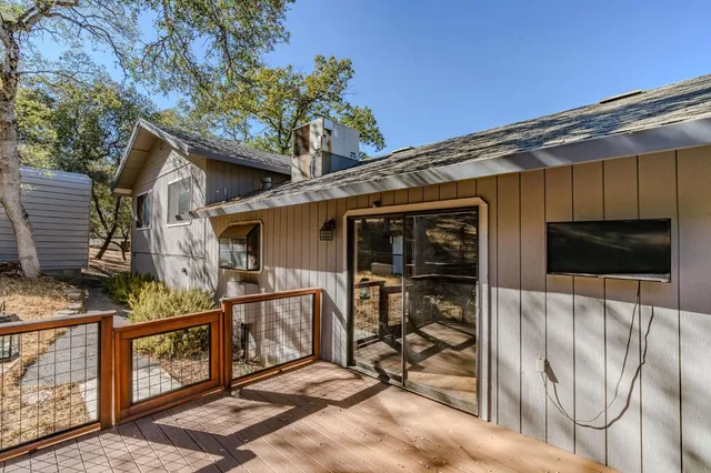a view of a house with backyard and deck