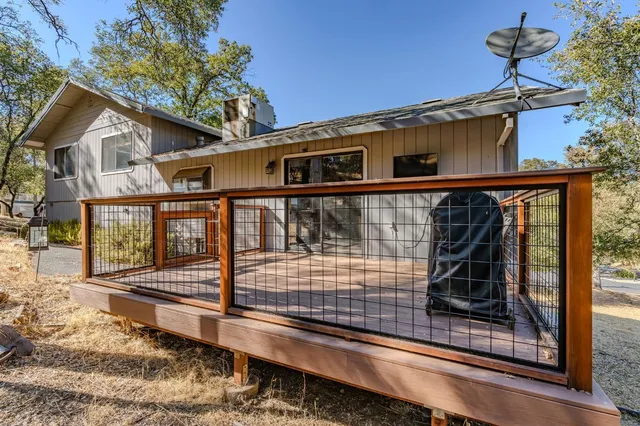a balcony with wooden floor and outdoor seating