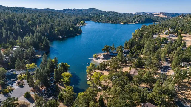 a backyard of a house with a garden and outdoor seating