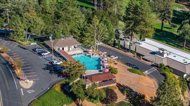 an aerial view of a city with lots of residential buildings and mountain view in back