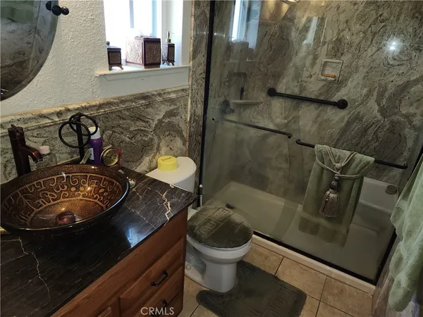 a bathroom with a toilet mirror and sink
