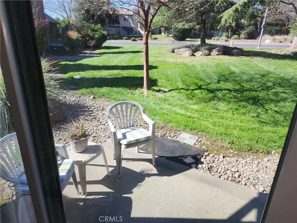a view of a backyard with sitting area and garden