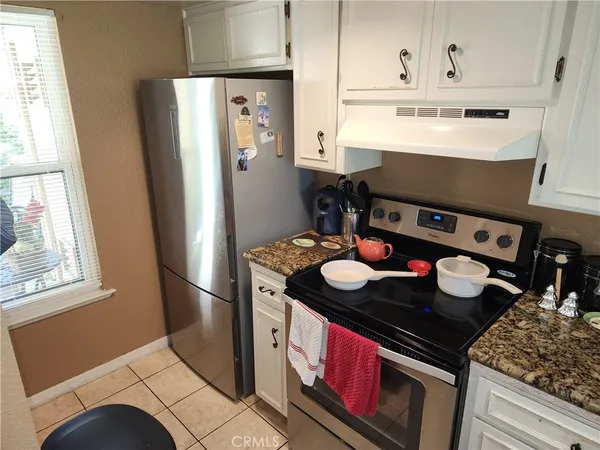 a kitchen with stainless steel appliances granite countertop a stove and a refrigerator