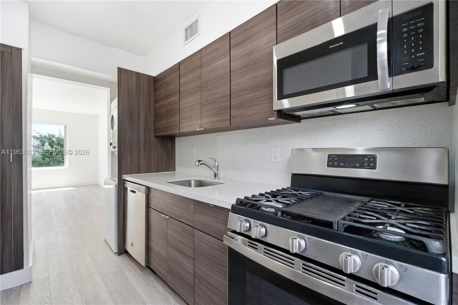 732 82nd Street, Unit 1 Miami Beach, FL 33141 - Photo 2 of 11 a kitchen with a stove and a microwave