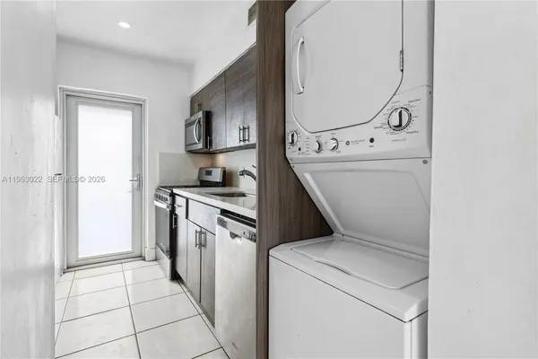 a kitchen with a stove top oven and cabinets