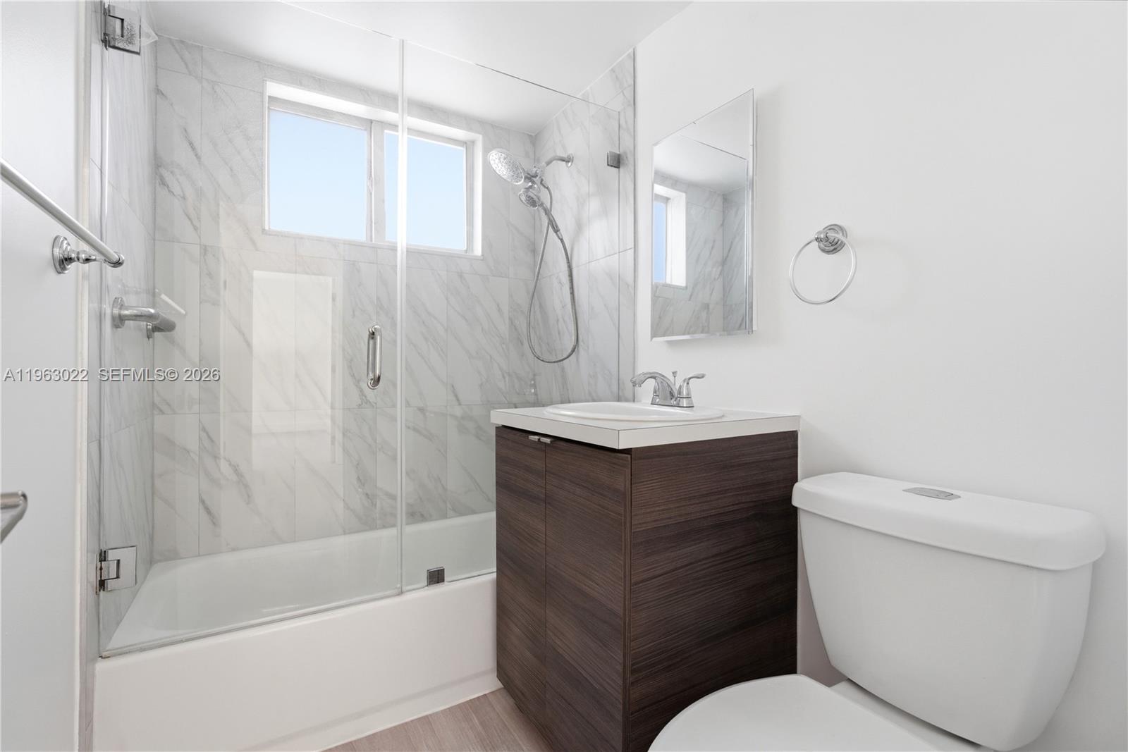 732 82nd Street, Unit 1 Miami Beach, FL 33141 - Photo 5 of 11 a bathroom with a sink toilet and shower