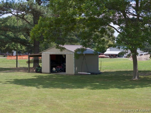 910 Possum Point Road Port Haywood, VA 23138 - Photo 41 of 47 Detached Shed with lean too great for lawn equipment garden tools